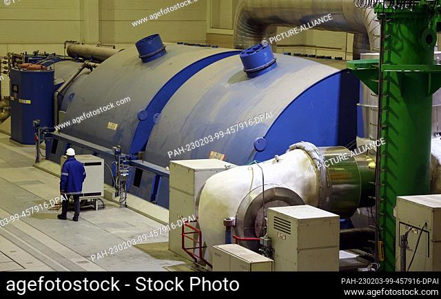 PRODUCTION - 02 February 2023, Mecklenburg-Western Pomerania, Rostock: Holger Kirsche, production manager, walks through the turbine engine house at the...