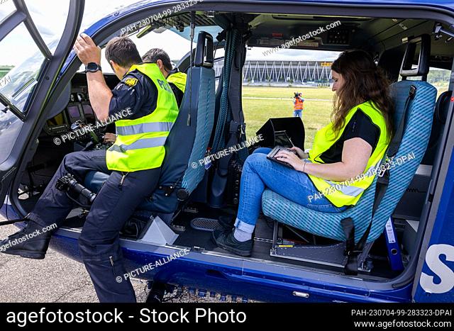 04 July 2023, Baden-Württemberg, Freiburg im Breisgau: Birgit Seiler (r), engineer of the Federal Office for Radiation Protection (BfS) sits in a helicopter of...