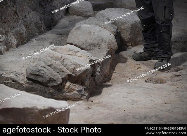 04 November 2021, Mecklenburg-Western Pomerania, Stralsund: Archaeologist Jörg Ansorge stands at a fieldstone foundation of a chapel in the choir of the former...