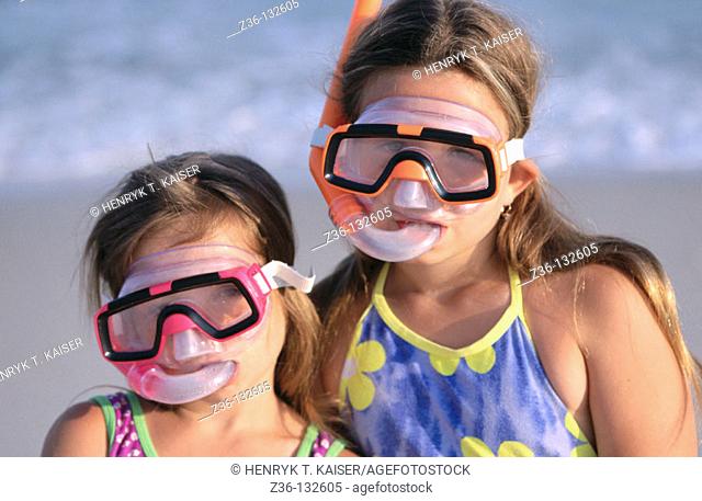 Girl on a beach with diving masks