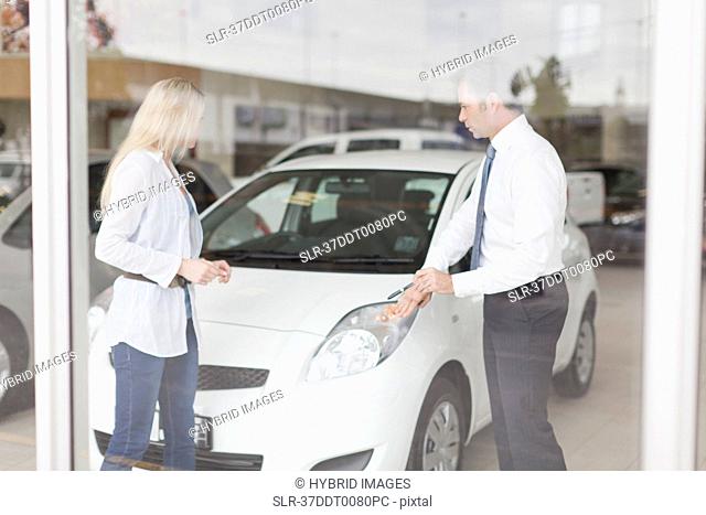 Car salesman showing car to customer