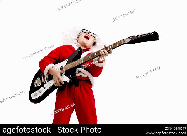 Boy dressed as Santa Claus with a guitar on a white background