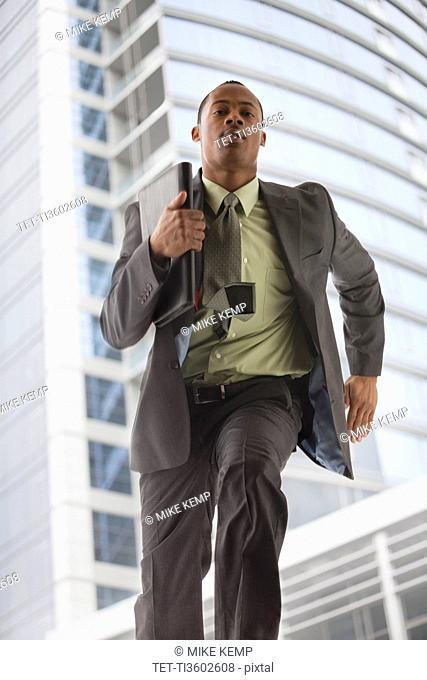 USA, Utah, Salt Lake City, Young businessman running in office building