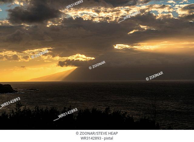 Sun setting behind the island of Molokai from Maui