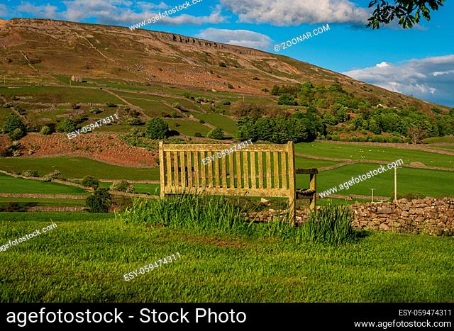 A bench overlooking the Arkengarthdale landscape near Reeth, North Yorkshire, England, UK