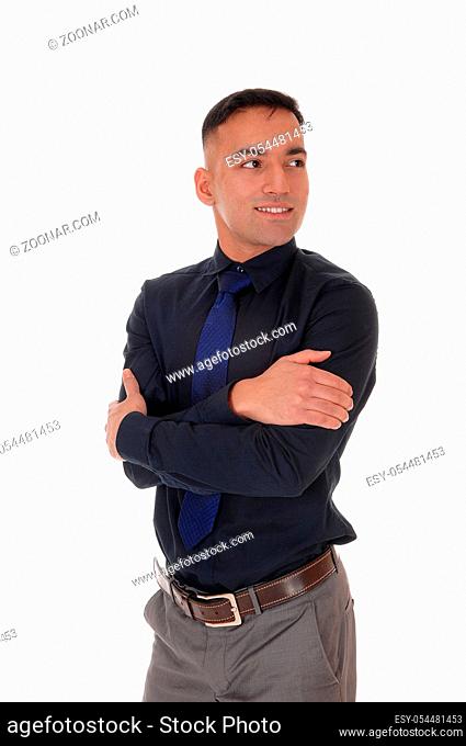 A handsome east Indian business man standing in the studio isolated over white background, in a black shirt with his arms crossed