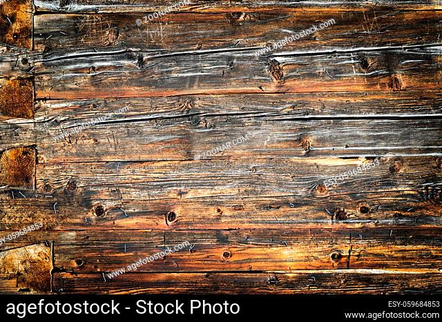 Old weathered brown wood wall. Wooden wall background design. Wood planks, boards are old with a beautiful rustic look. Nice studio lighting and elegant...