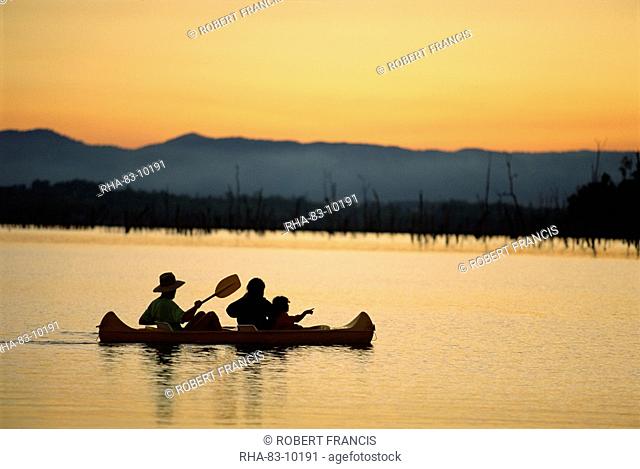 Family canoeing on Lake Tinaroo, a recreation area on the Atherton Tableland in Queensland, Australia, Pacific