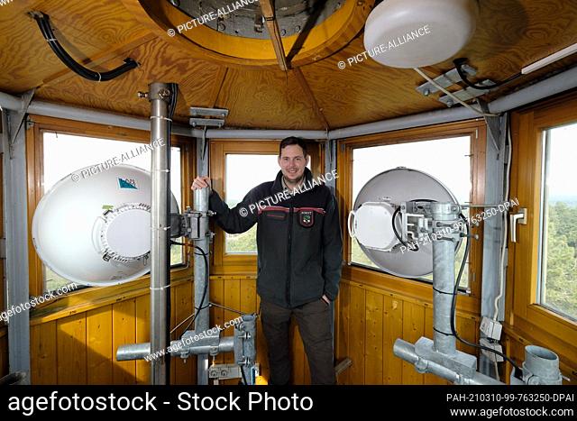 10 March 2021, Saxony-Anhalt, Arnsdorf: Philipp Nahrstedt, head of the forestry office for the Annaburg area, stands inside a fire watch tower at directional...