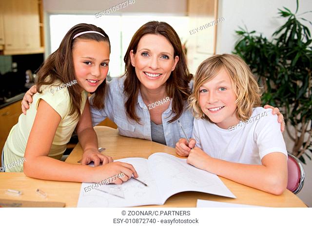 Mother helping her children with homework