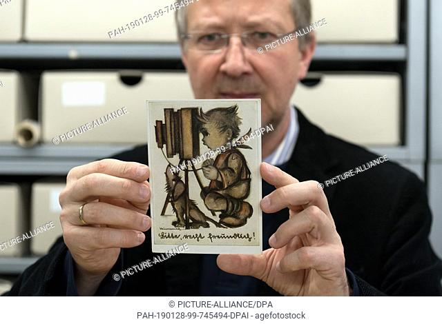 18 January 2019, Berlin: Veit Didczuneit, Head of Department Collections at the Museum of Communication, looks at a field postcard with the imprint ""Bitte