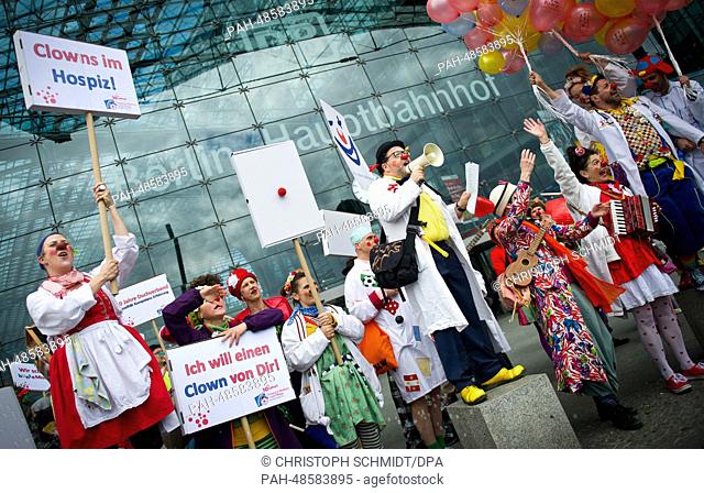 Hospital clowns with portest signs which reads 'Clownsat the hospice' and 'I want a clown from you' demonstrate during a rally of the umbrella organization of...