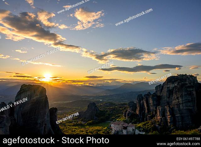 Greece. Summer sunset over valley of the rock monasteries in Meteora (near Kalambaka) and sunbeams
