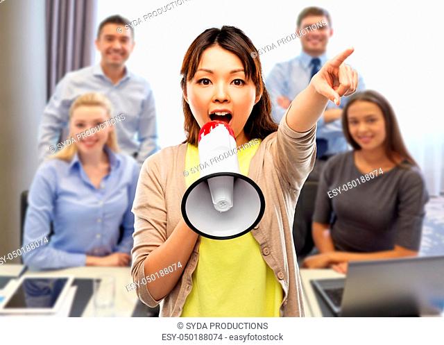 asian woman speaking to megaphone over office team