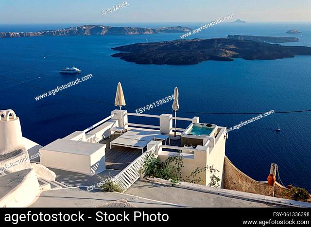 Imerovigli, Santorini, Greece - June 29, 2021: Whitewashed houses with terraces and pools and a beautiful view in Imerovigli on Santorini island, Greece