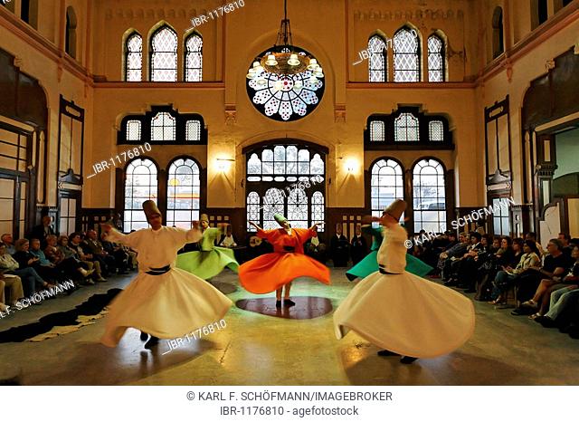Dancing dervishes of the Sufi order Mevlevi, Sema ceremony, historic train station Sirkeci, Istanbul, Turkey