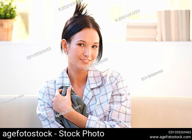 Portrait of pretty girl in pyjama smiling at camera