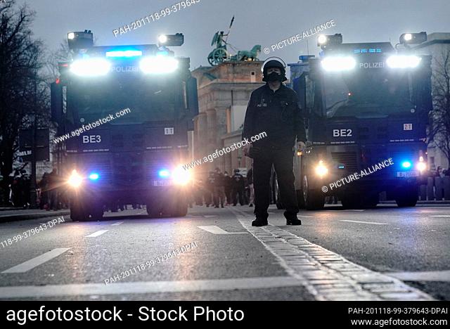 18 November 2020, Berlin: Police water cannons stand at the Brandenburg Gate during a demonstration against the corona restrictions of the federal government