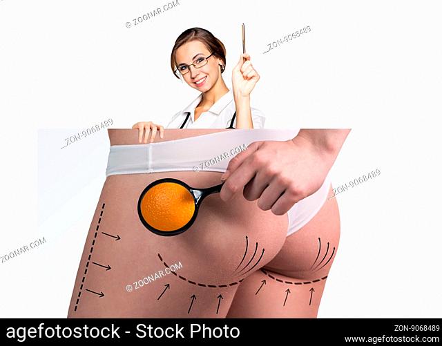 Female doctor holds placard with woman battocks and correction lines on them. Plastic surgery concept