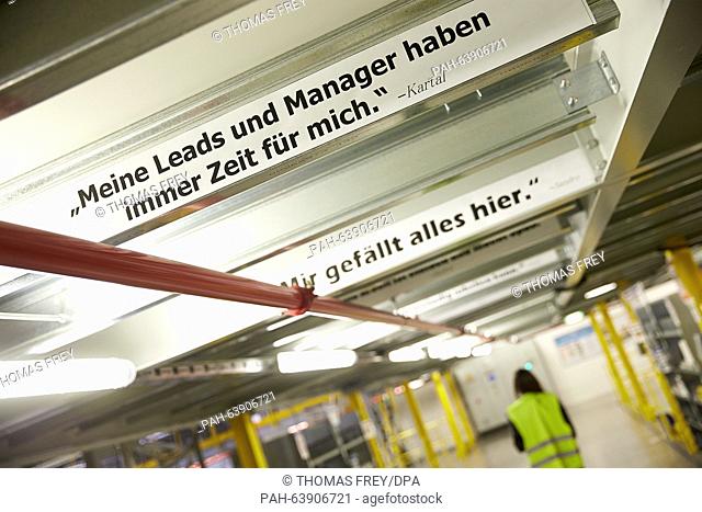 Banners that read 'My leads and managers always have time for me.' and 'I like everything here.' pictured at the Amazon logistics centre in Koblenz, Germany