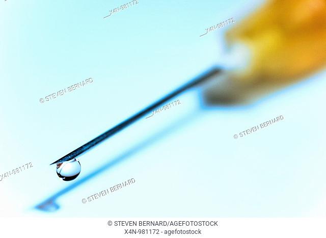 Hypodermic needle with drop of fluid at tip