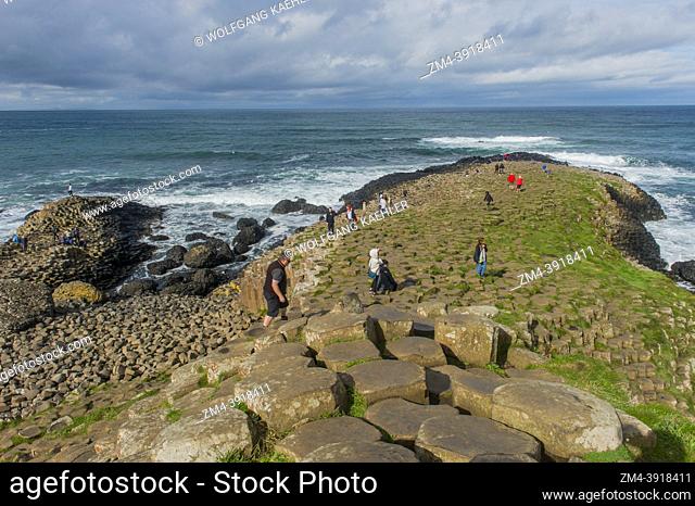 People on the basalt columns of the Giants Causeway, a UNESCO World Heritage Site, near Bushmills and Portrush on North Antrim Coast, County Antrim