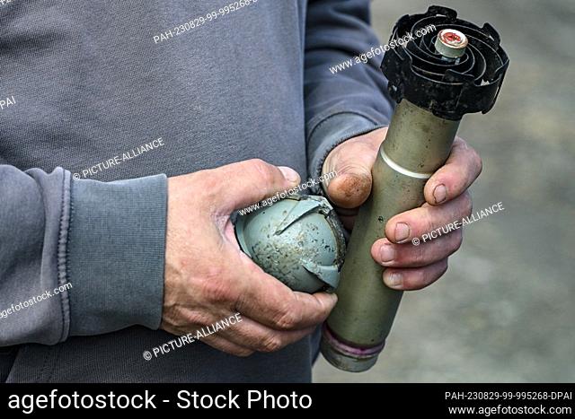 PRODUCTION - 09 August 2023, Brandenburg, Neuglienicke: Cluster munitions from Russian production can be seen on the former military training area in...