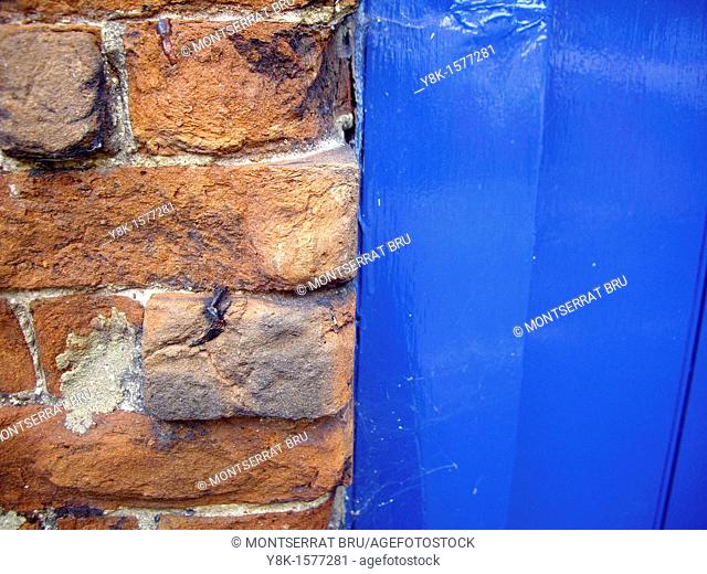 Brick wall and blue door