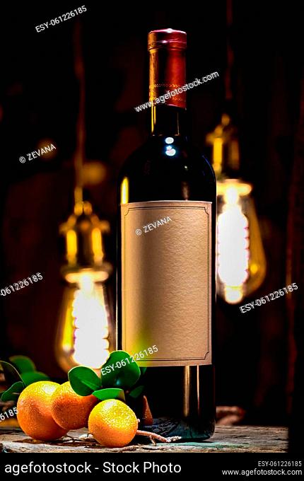 Red wine and ripe mandarins on a background of vintage lamps