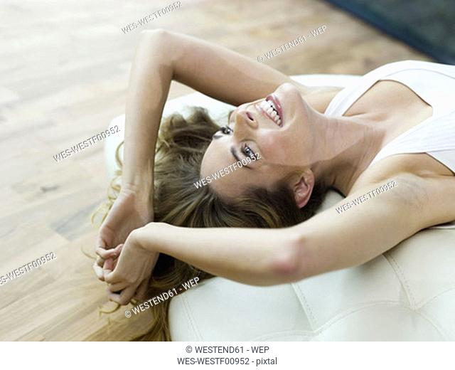 Woman lying on bed, smiling, elevated view
