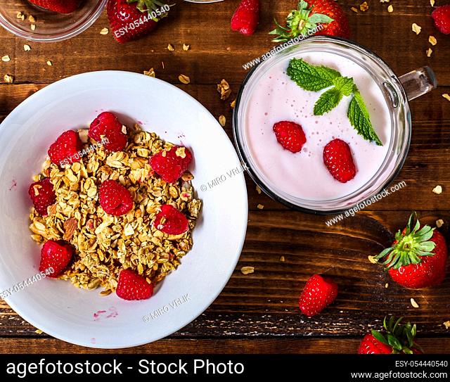Smoothie with granola berries and table top view