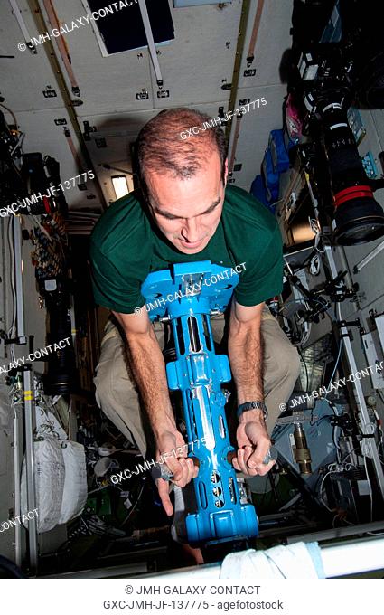 NASA astronaut Rick Mastracchio, Expedition 38 flight engineer, uses a body mass measurement device (BMMD) in the Zvezda Service Module of the International...