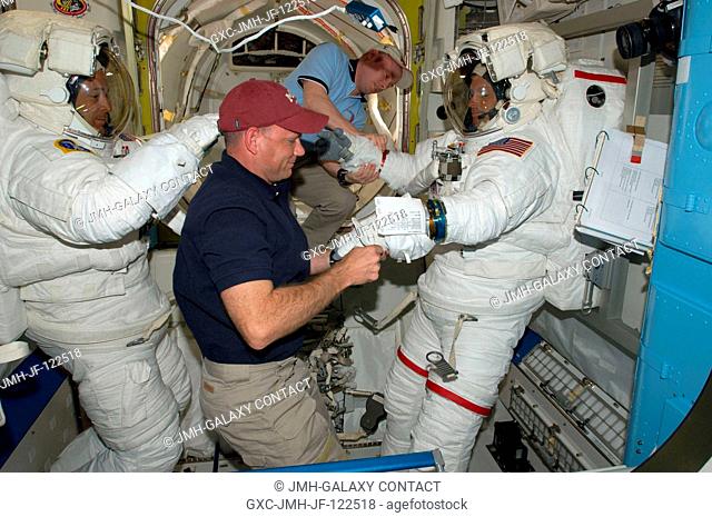 Astronauts Steve Swanson (right) and Richard Arnold, both STS-119 mission specialists, attired in their Extravehicular Mobility Unit (EMU) spacesuits