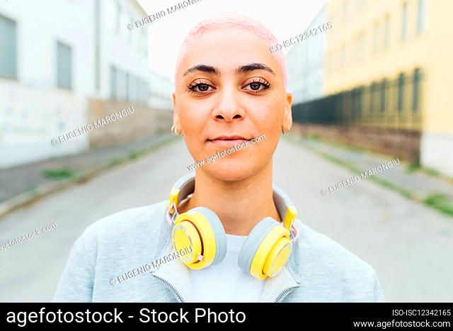 Head and should portrait of young woman with headphones