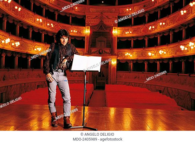 Italian singer-songwriter Luciano Ligabue (Luciano Riccardo Ligabue) posing on the stage at the Theatre Asioli and leaning a hand on the music stand in a...