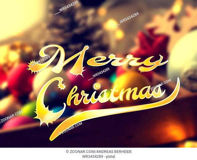 Colorful Christmas background with blurred Christmas decoration and the words Merry Christmas