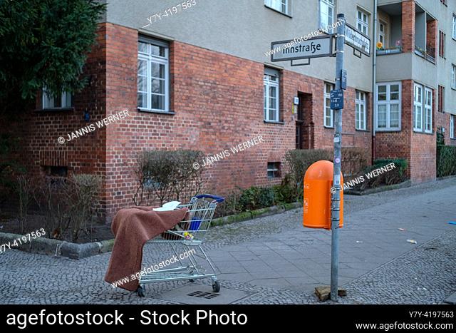 Discarded shopping cart and other detrius on the streets of Berlin-Neukölln, Germany
