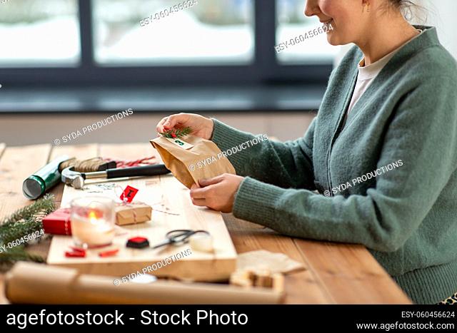 woman making christmas advent calendar at home