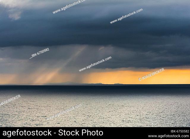 Rain clouds at sunset, Fletcher Bay, Coromandel, North Island, New Zealand, Oceania