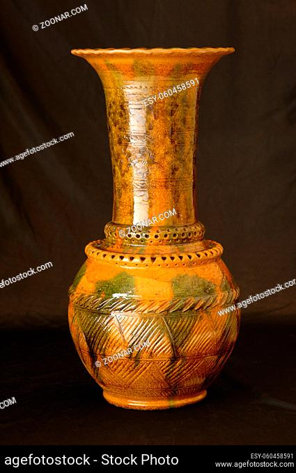 oriental antique ceramic vase on a black background closeup