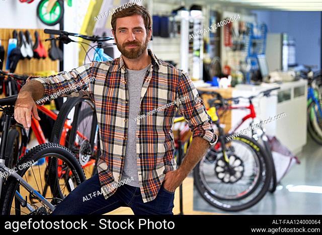 Owner standing in bicycle shop
