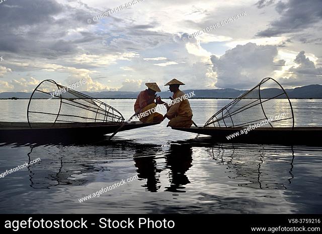 Myanmar, Shan State, Inle Lake, Intha fishermen lighting a cigar