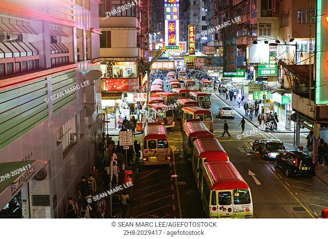Mini Buses queue in gridlock traffic in Mongkok, Hong Kong at night