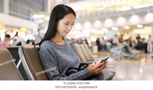 Woman using cellphone in Hong Kong airport