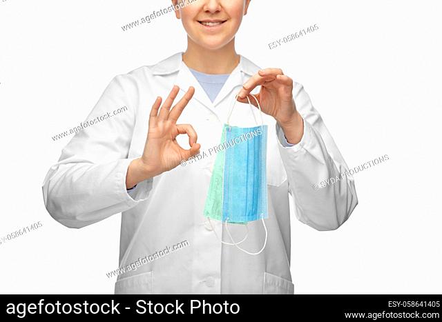 smiling doctor with two masks showing ok sign