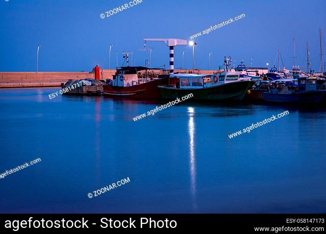 Sunset or blue hour in quiet fishermen port of l'Ampolla, Delta del Ebro in Spain. Mediterranean Sea