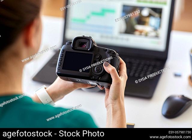 woman with camera and video editor on laptop