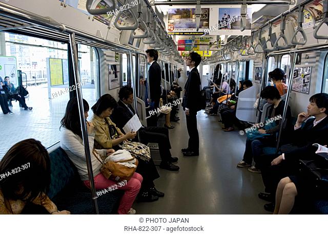 Passengers riding aboard the Yamanote loop line train that encircles greater metropolitan Tokyo, Japan, Asia