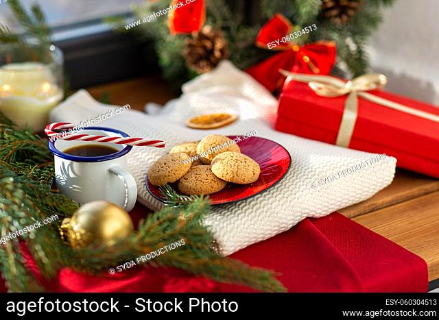 cookies, coffee and christmas gift on sill at home