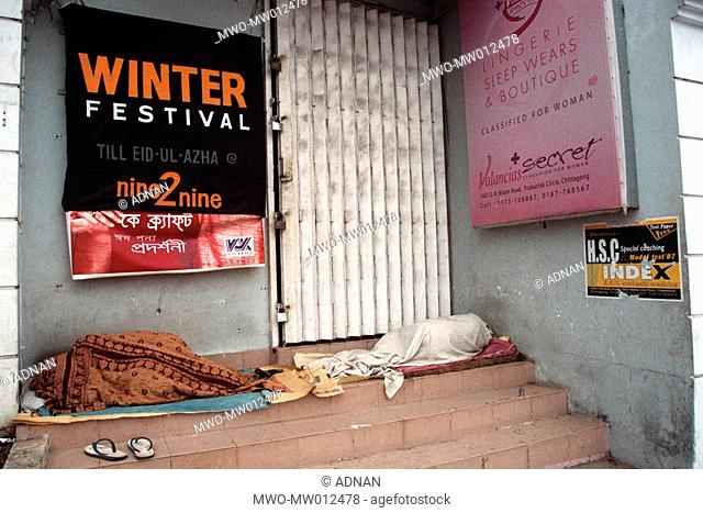 Homeless people finding some space to sleep at a storefront Chittagong, Bangladesh September, 2007